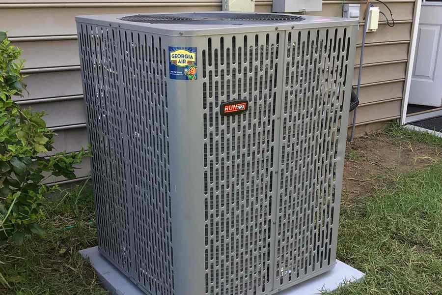 Outdoor air conditioning unit installed beside a house