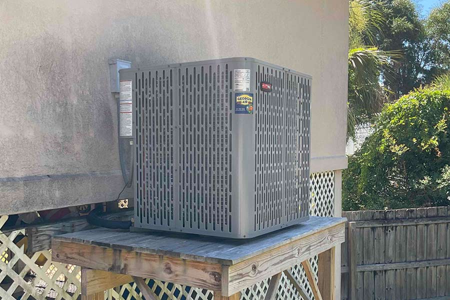 An outdoor RunTru HVAC unit installed on an elevated wooden platform
