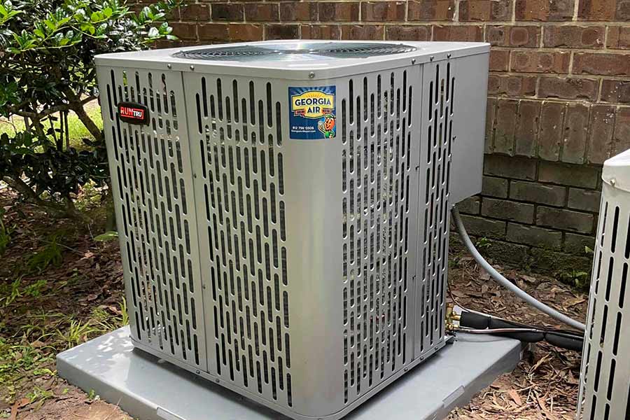 HVAC condenser unit by Trane installed outdoors on a concrete pad