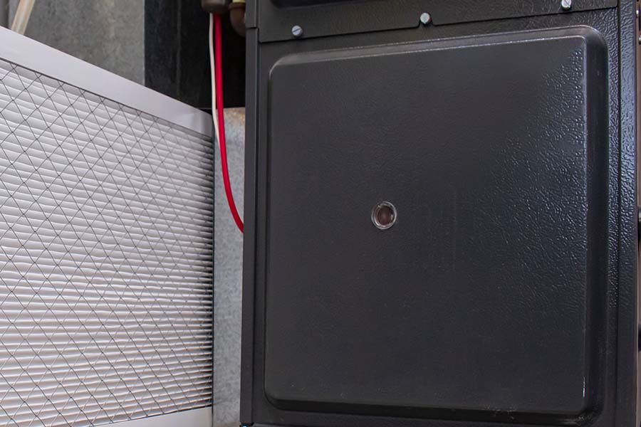New furnace filter next to furnace unit