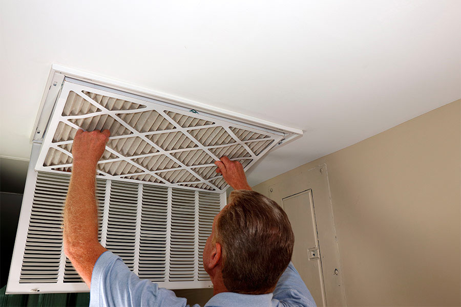 Technician replacing air filter